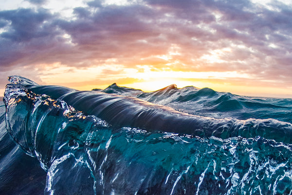 deep blue, purple waves with a stunning sunset