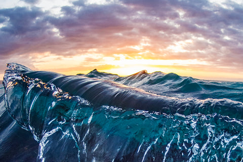 deep blue, purple waves with a stunning sunset