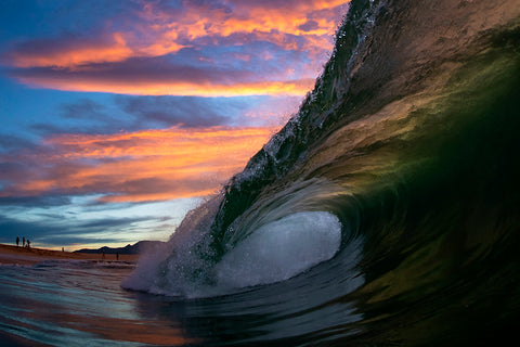 breaking wave with stunning sunset